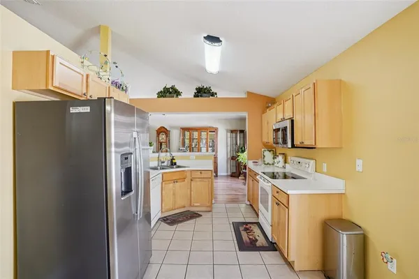 a kitchen with a sink stove and microwave