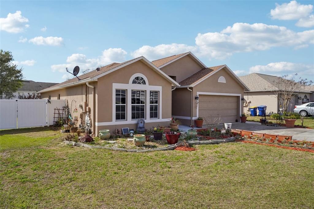 2315 Belfry Way Mascotte, FL 34753 - Photo 2 of 55 a front view of a house with patio