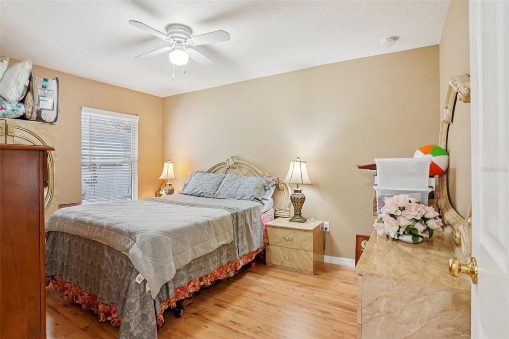 2315 Belfry Way Mascotte, FL 34753 - Photo 29 of 55 a bedroom with a bed and a chandelier