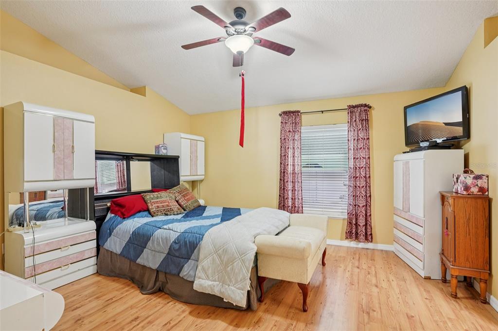 2315 Belfry Way Mascotte, FL 34753 - Photo 32 of 55 a bedroom with a bed and a flat screen tv
