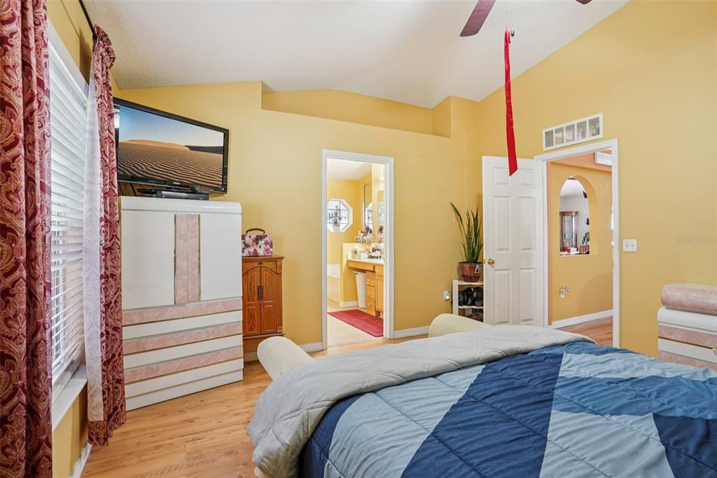 2315 Belfry Way Mascotte, FL 34753 - Photo 33 of 55 a bedroom with a bed and a flat screen tv