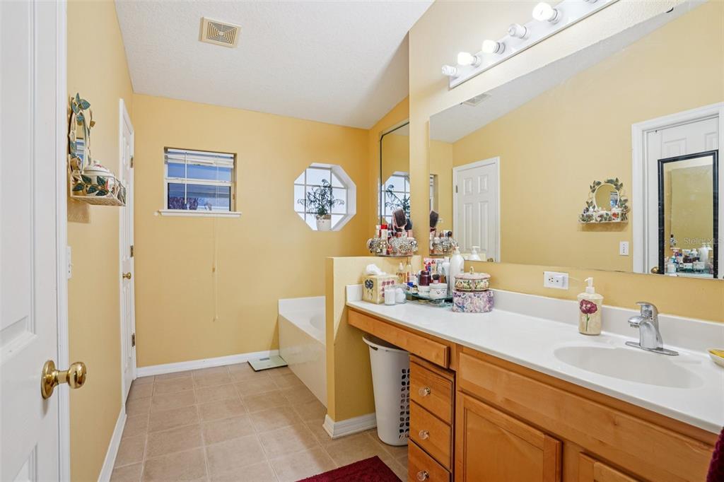 2315 Belfry Way Mascotte, FL 34753 - Photo 34 of 55 a bathroom with a double vanity sink mirror and toilet