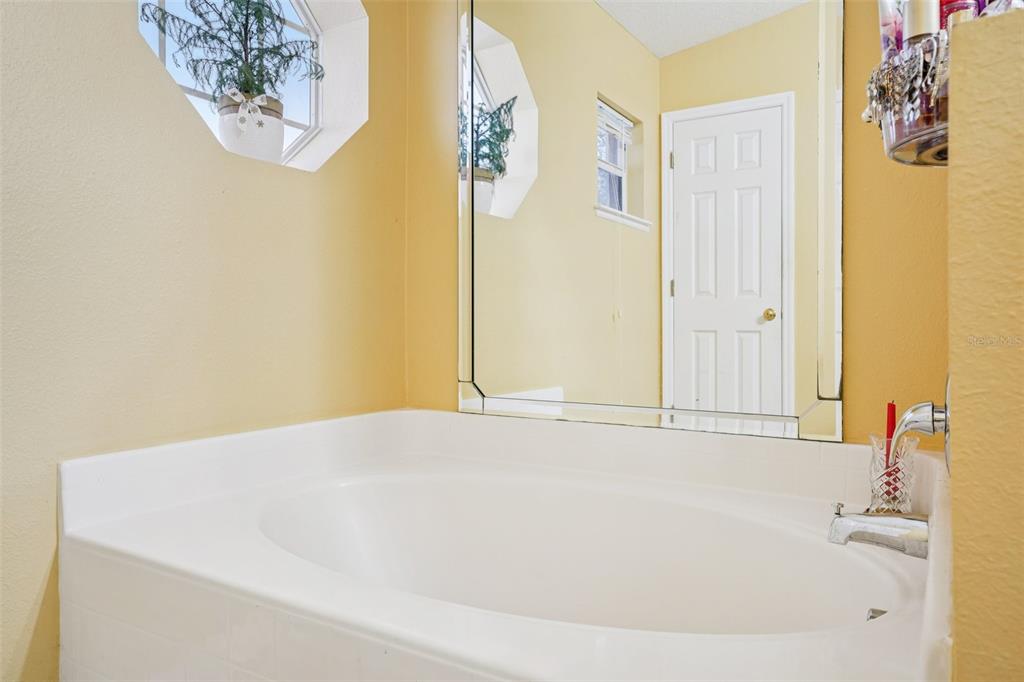2315 Belfry Way Mascotte, FL 34753 - Photo 36 of 55 a bathroom with a bathtub and a shower
