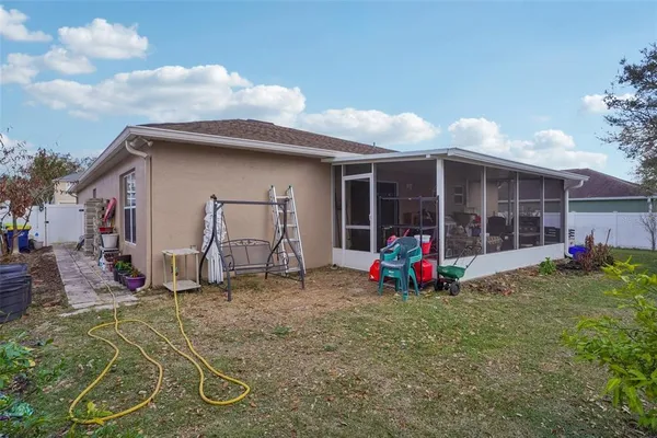 a backyard of a house with table and chairs