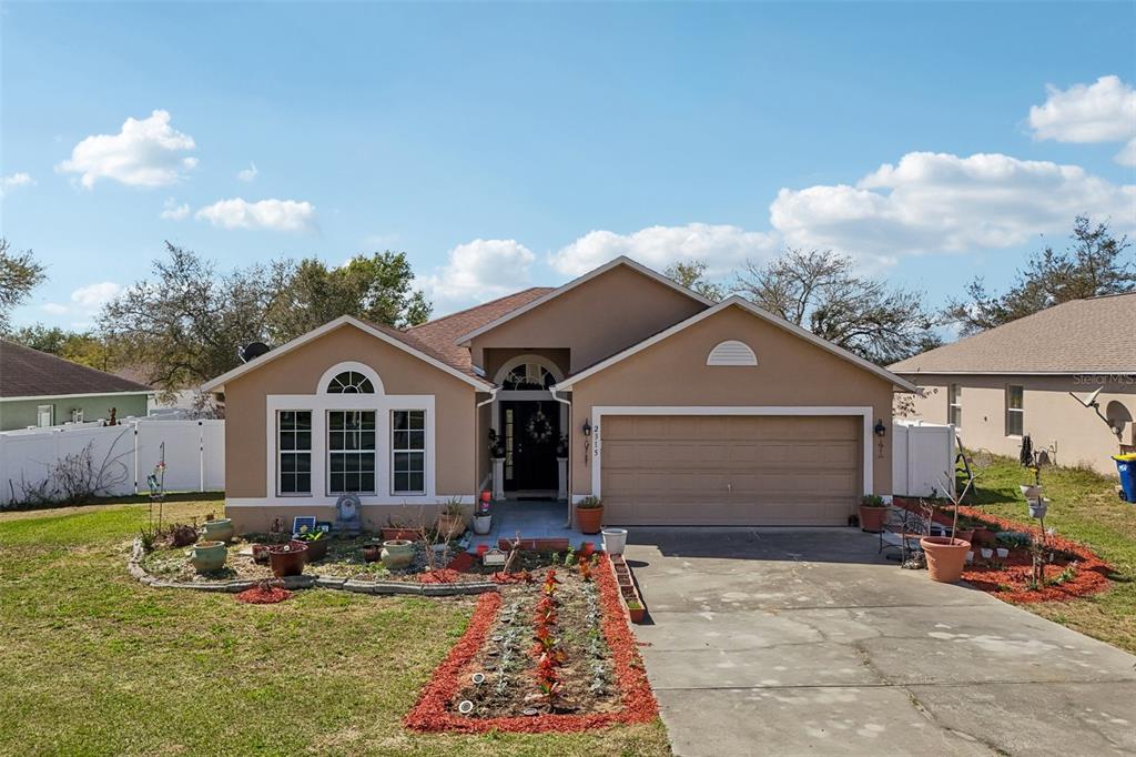 2315 Belfry Way Mascotte, FL 34753 - Photo 45 of 55 a front view of a house with garden