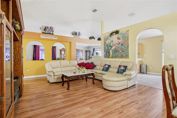 a living room with furniture and wooden floor