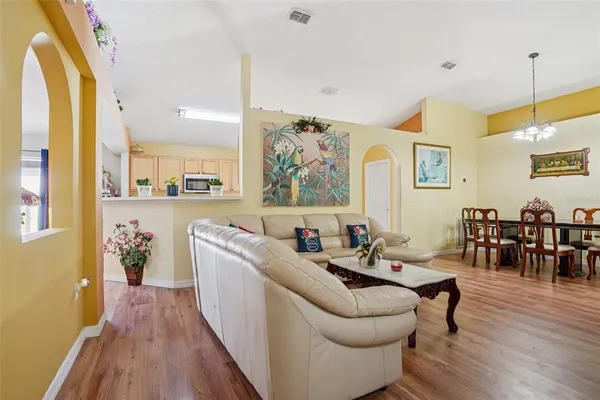 a living room with furniture and wooden floor