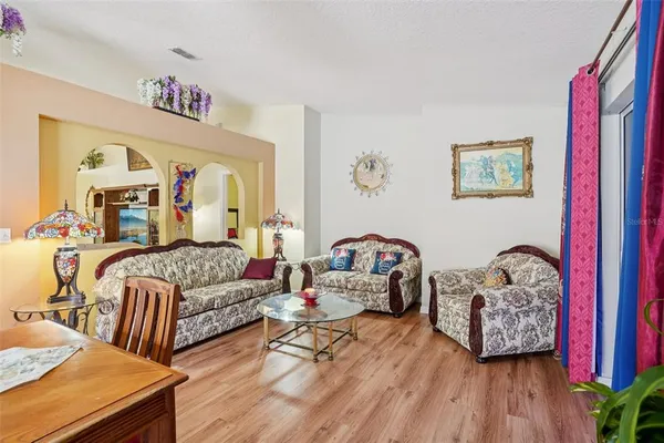 a living room with furniture and wooden floor