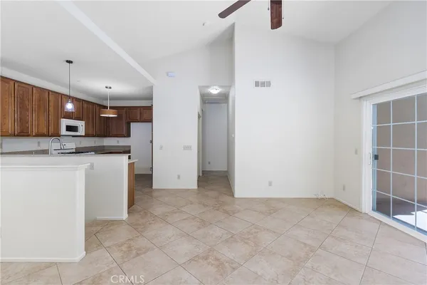 a view of kitchen with granite countertop cabinets and sink