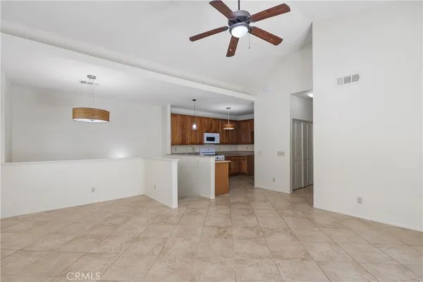 a kitchen with stainless steel appliances granite countertop a sink refrigerator and cabinets