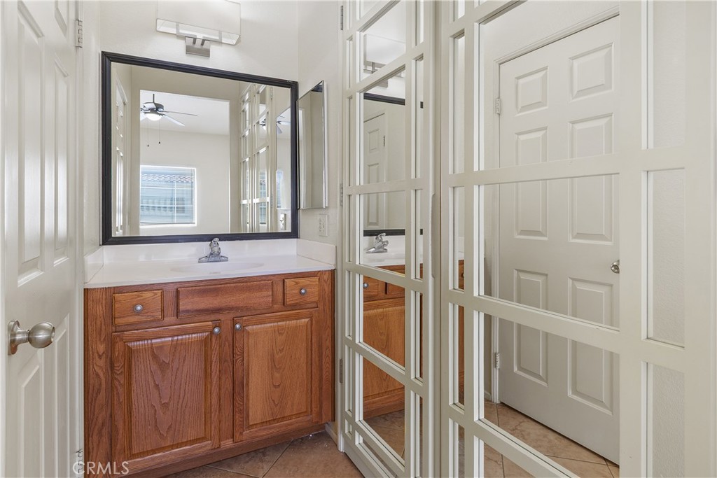 93 Kansas Street, Unit 202 Redlands, CA 92373 - Photo 27 of 40 a bathroom with a sink a mirror and vanity