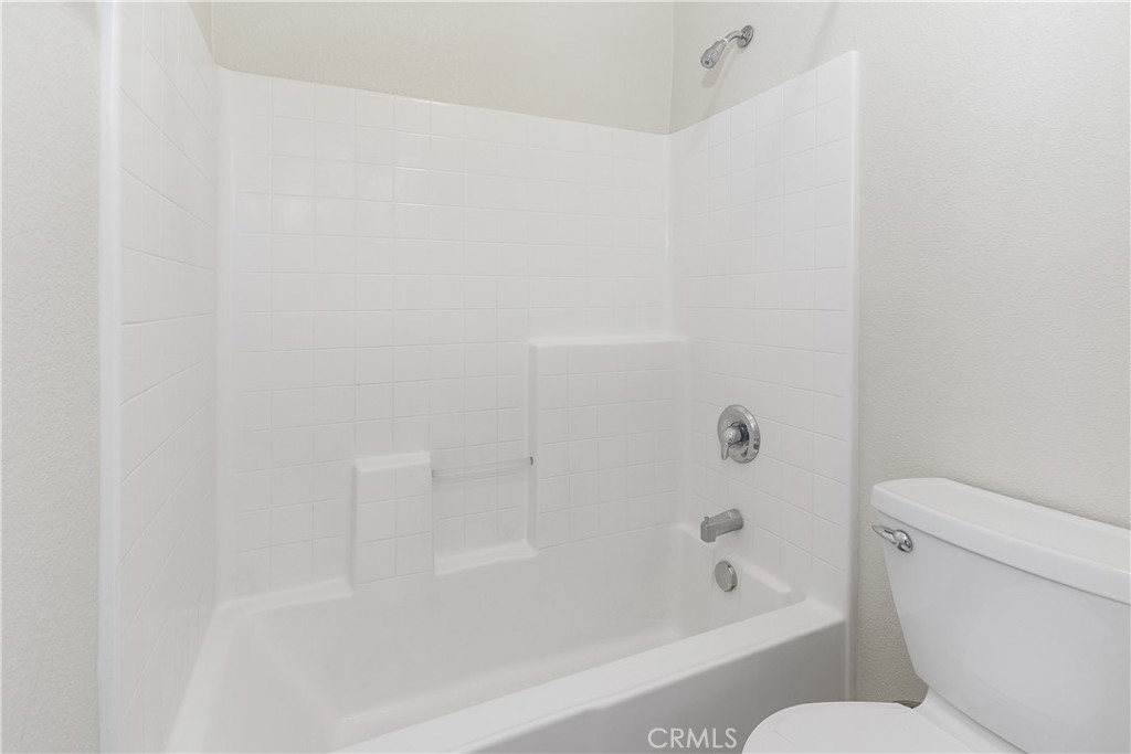 93 Kansas Street, Unit 202 Redlands, CA 92373 - Photo 28 of 40 a bathroom with a shower and a toilet