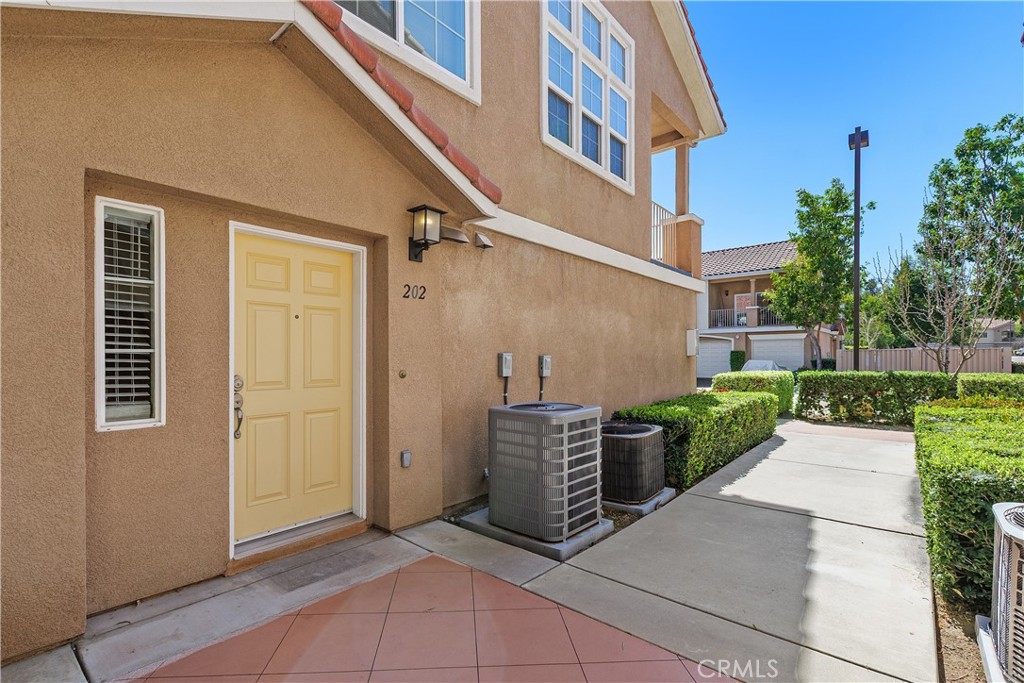 93 Kansas Street, Unit 202 Redlands, CA 92373 - Photo 5 of 40 an outdoor view of a house with entryway