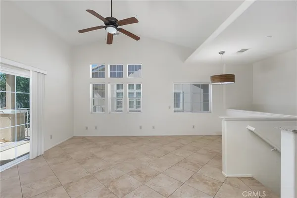 a view of empty room with ceiling fan