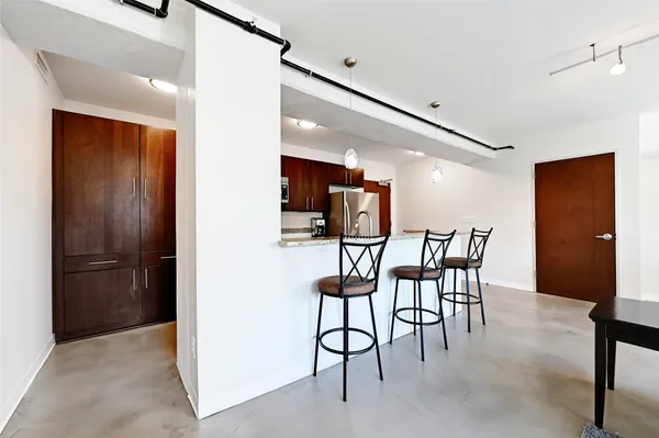 a view of a room with furniture and a ceiling fan