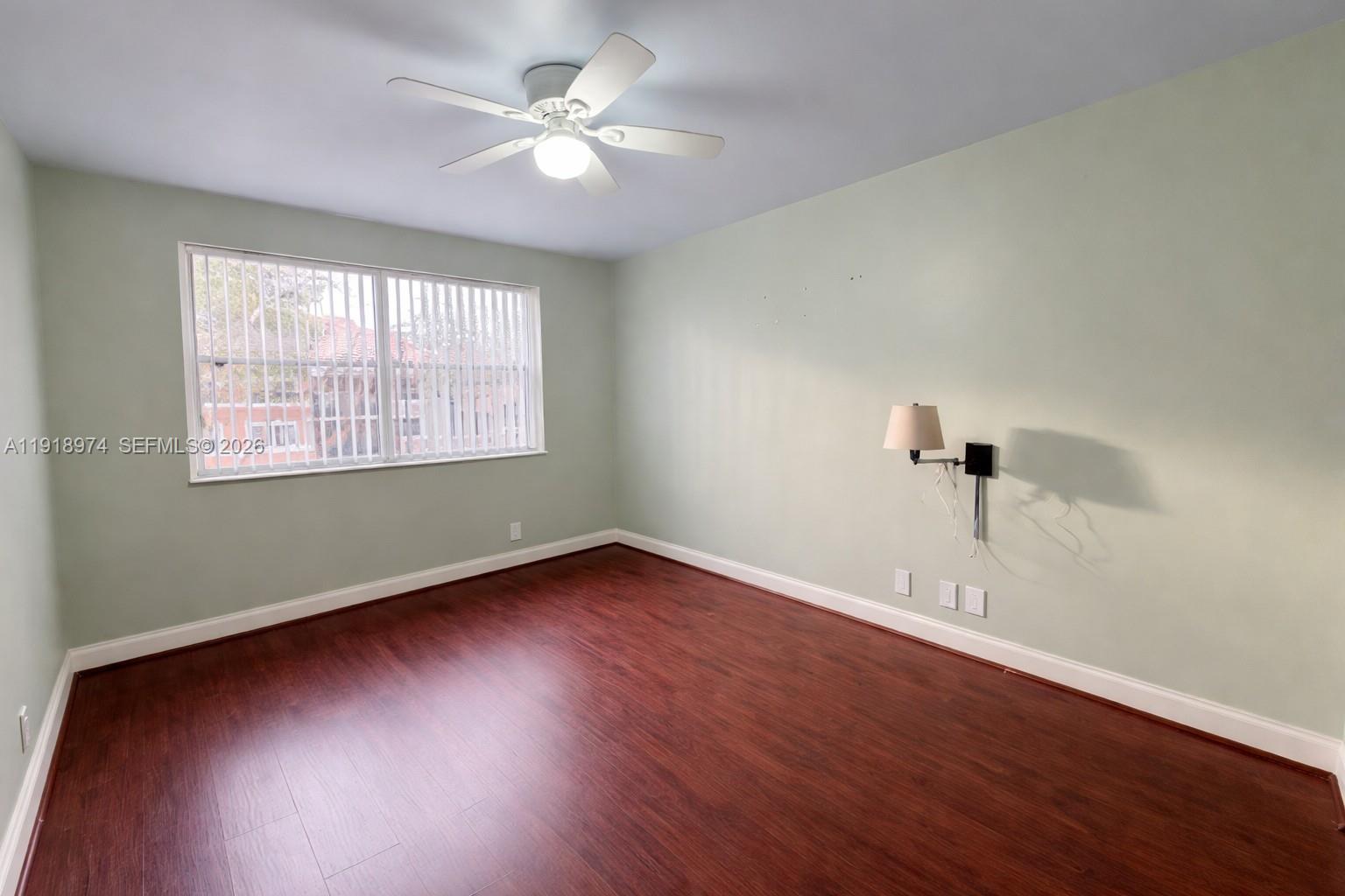 8801 Wiles Road, Unit 307 Coral Springs, FL 33067 - Photo 11 of 18 wooden floor in an empty room with a window