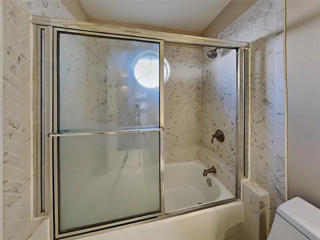 a bathroom with a glass shower door