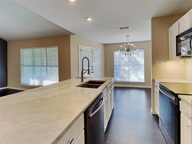 a kitchen with a stove and a sink