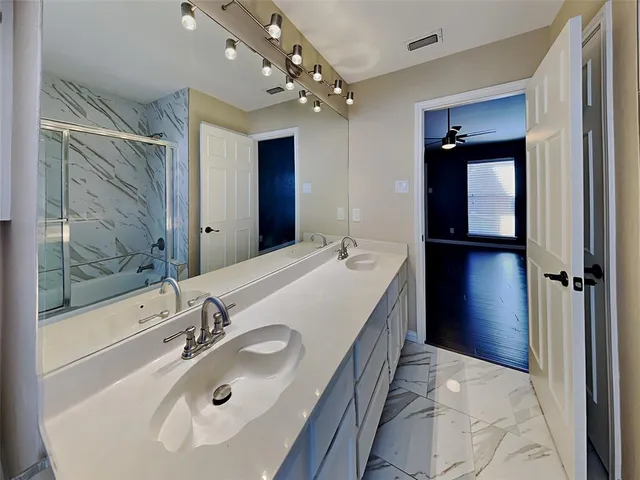 a bathroom with a sink double vanity and a mirror