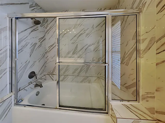 a bathroom with a shower and a bathtub