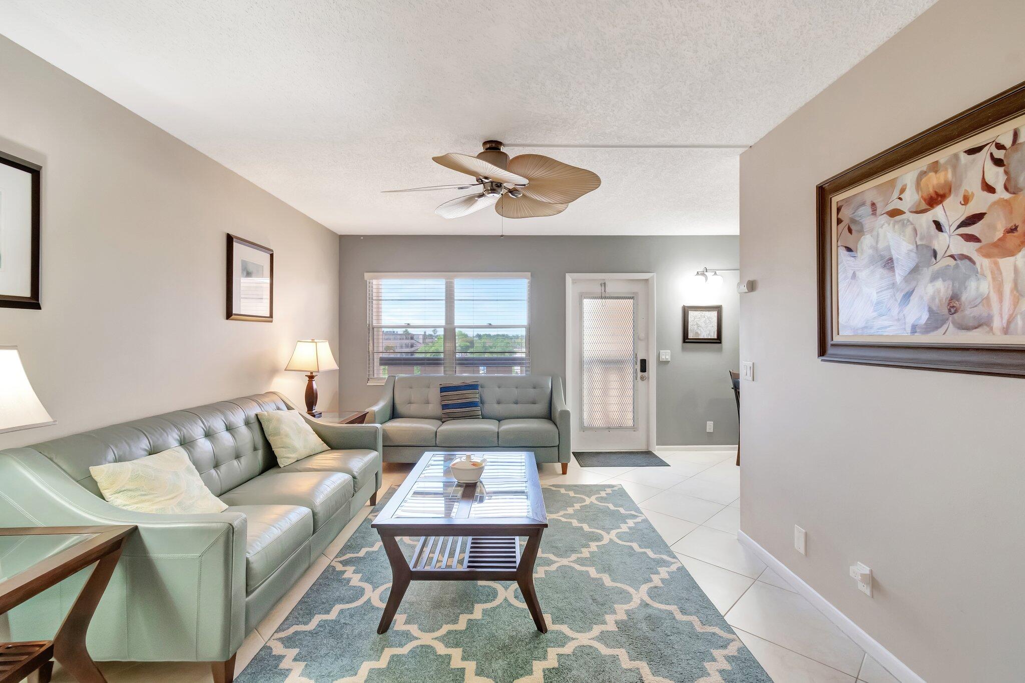 4049 Wolverton C Boca Raton, FL 33434 - Photo 20 of 88 a living room with furniture and a large window