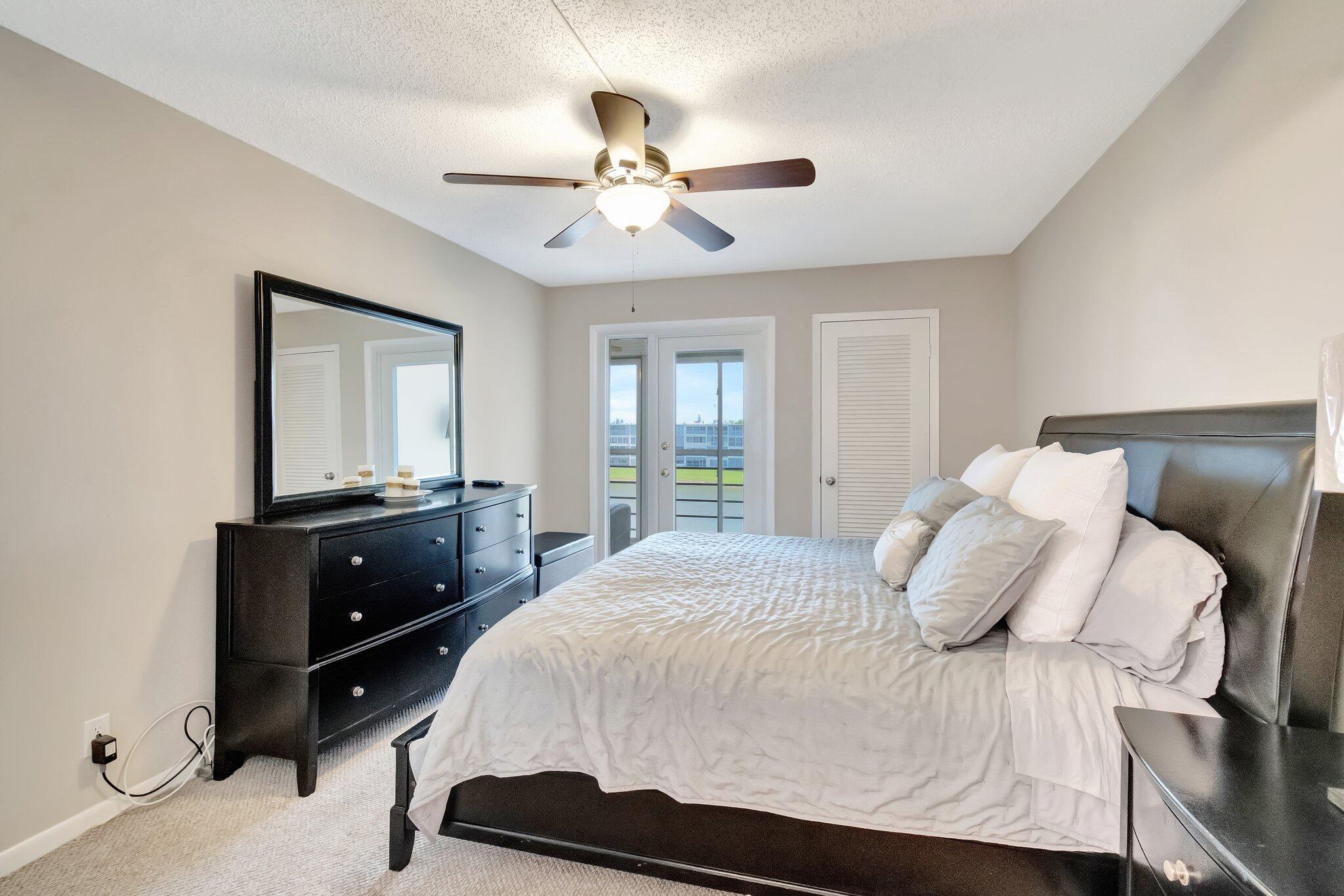 4049 Wolverton C Boca Raton, FL 33434 - Photo 22 of 88 a bedroom with a bed and a closet