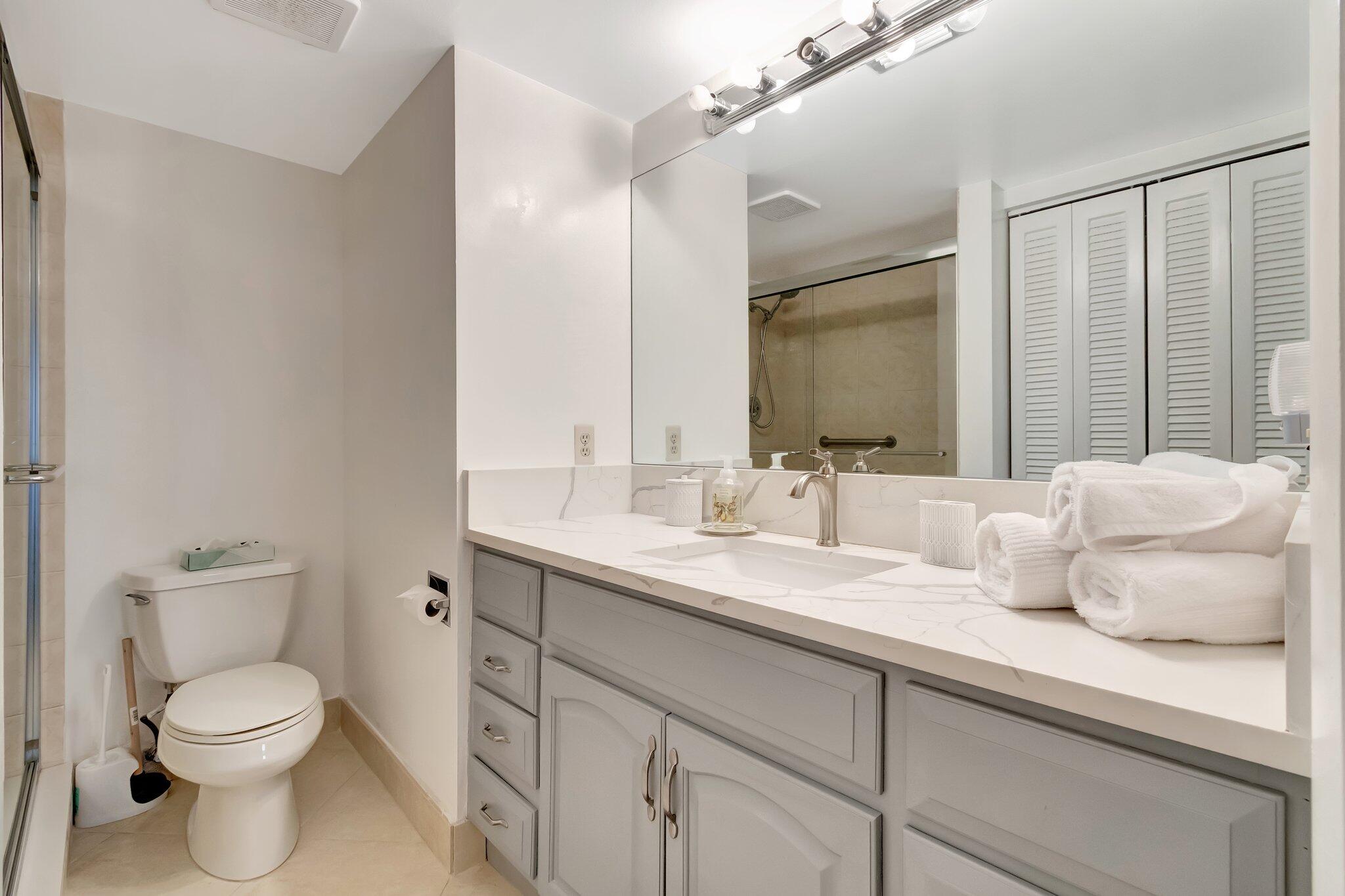 4049 Wolverton C Boca Raton, FL 33434 - Photo 25 of 88 a bathroom with a granite countertop sink mirror vanity and toilet
