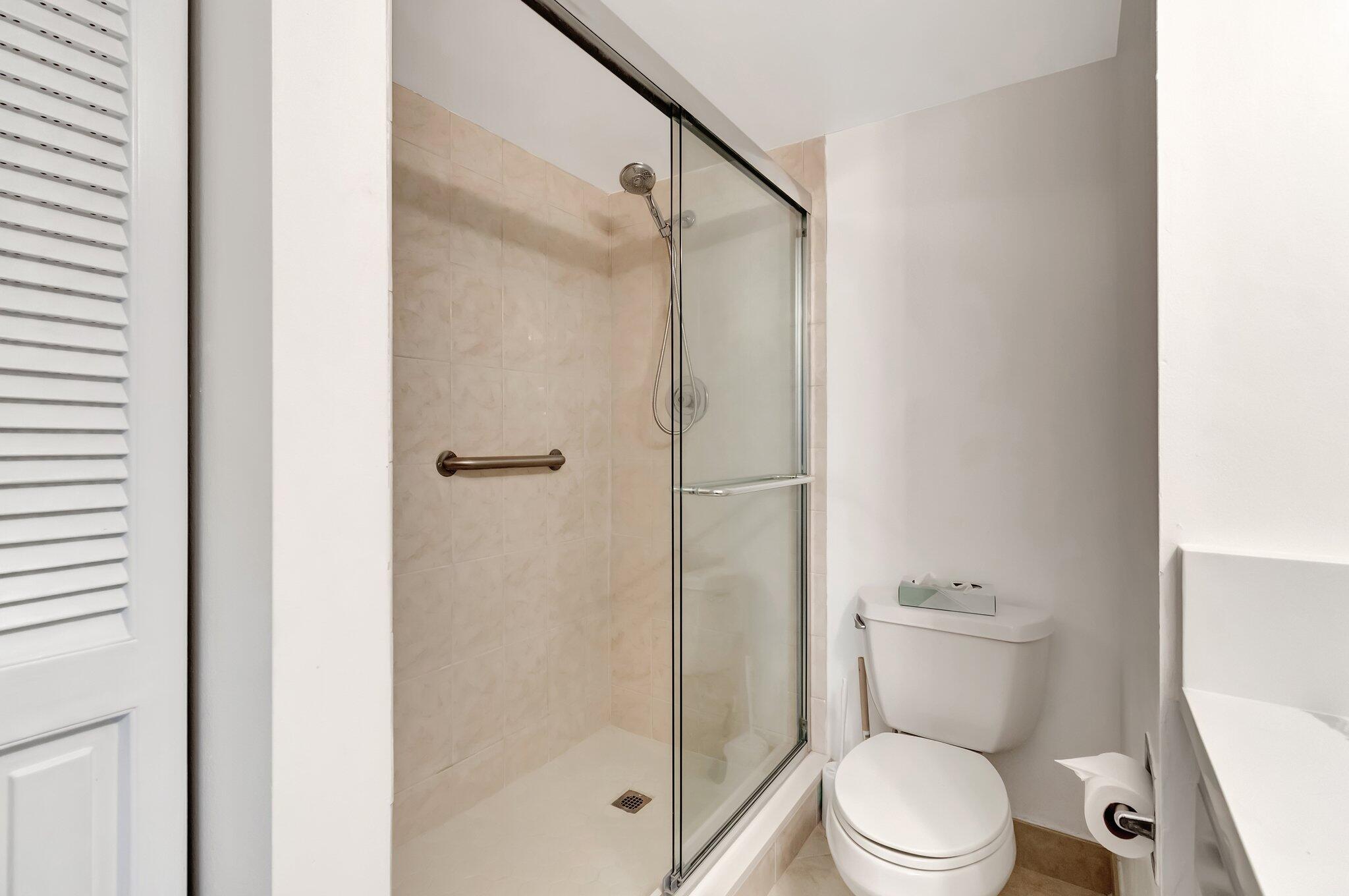 4049 Wolverton C Boca Raton, FL 33434 - Photo 26 of 88 a white toilet sitting next to a bathroom sink