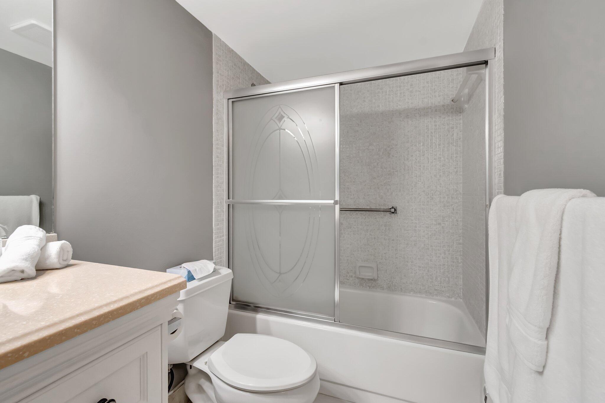 4049 Wolverton C Boca Raton, FL 33434 - Photo 29 of 88 a bathroom with a shower a toilet and sink