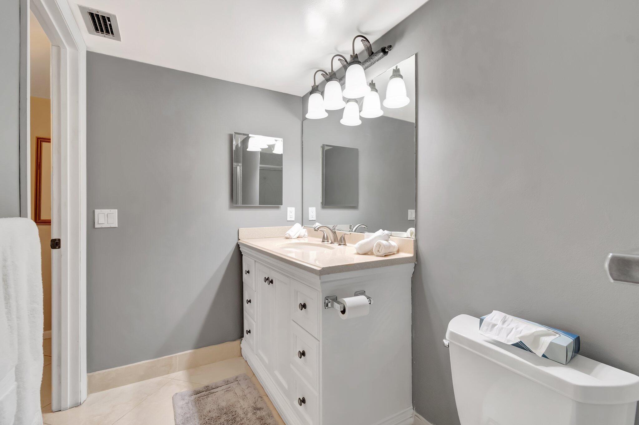 4049 Wolverton C Boca Raton, FL 33434 - Photo 30 of 88 a bathroom with a sink mirror and toilet