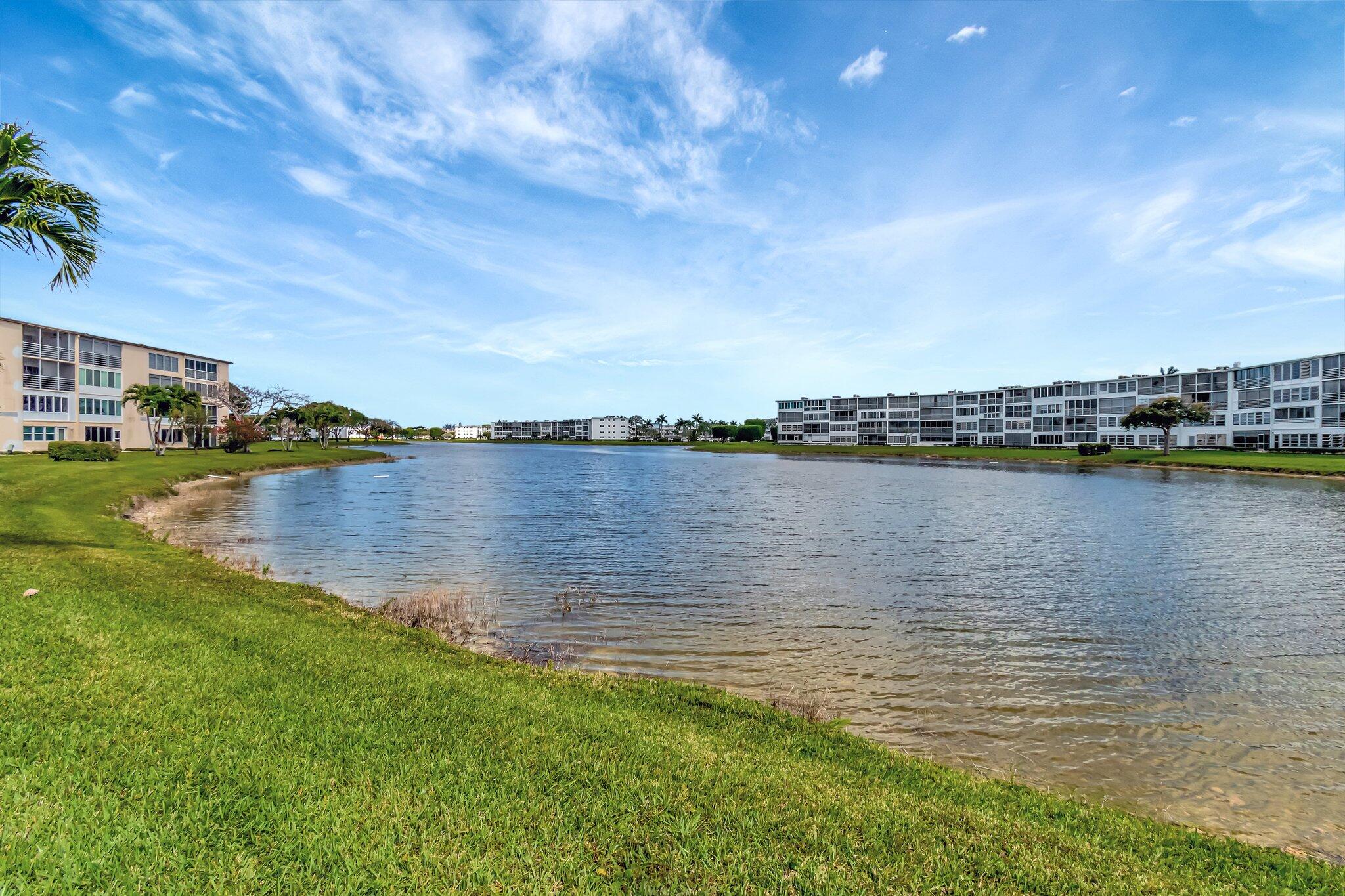 4049 Wolverton C Boca Raton, FL 33434 - Photo 39 of 88 a view of a lake with houses in the background