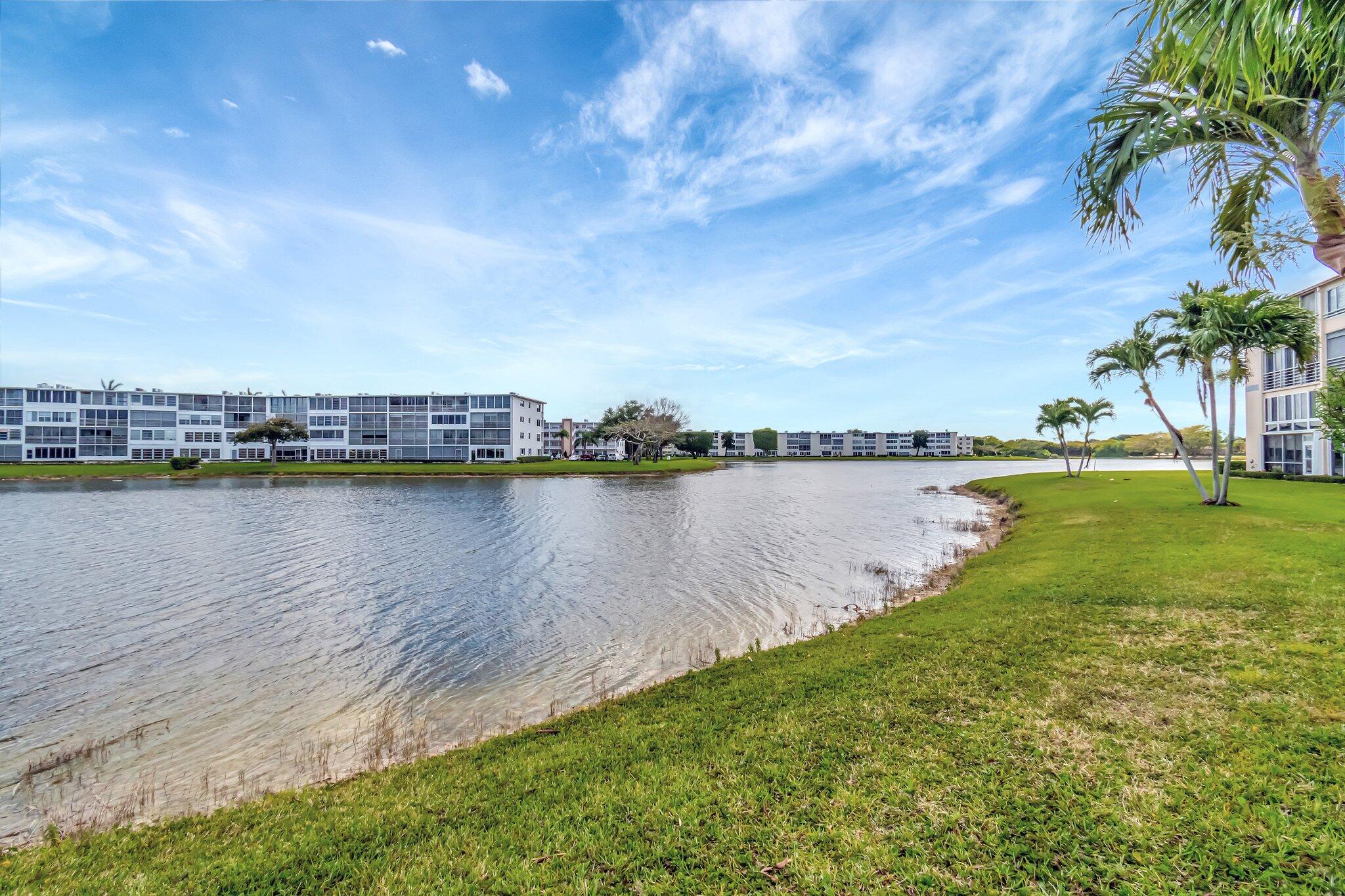 4049 Wolverton C Boca Raton, FL 33434 - Photo 42 of 88 a view of a lake with houses in the back