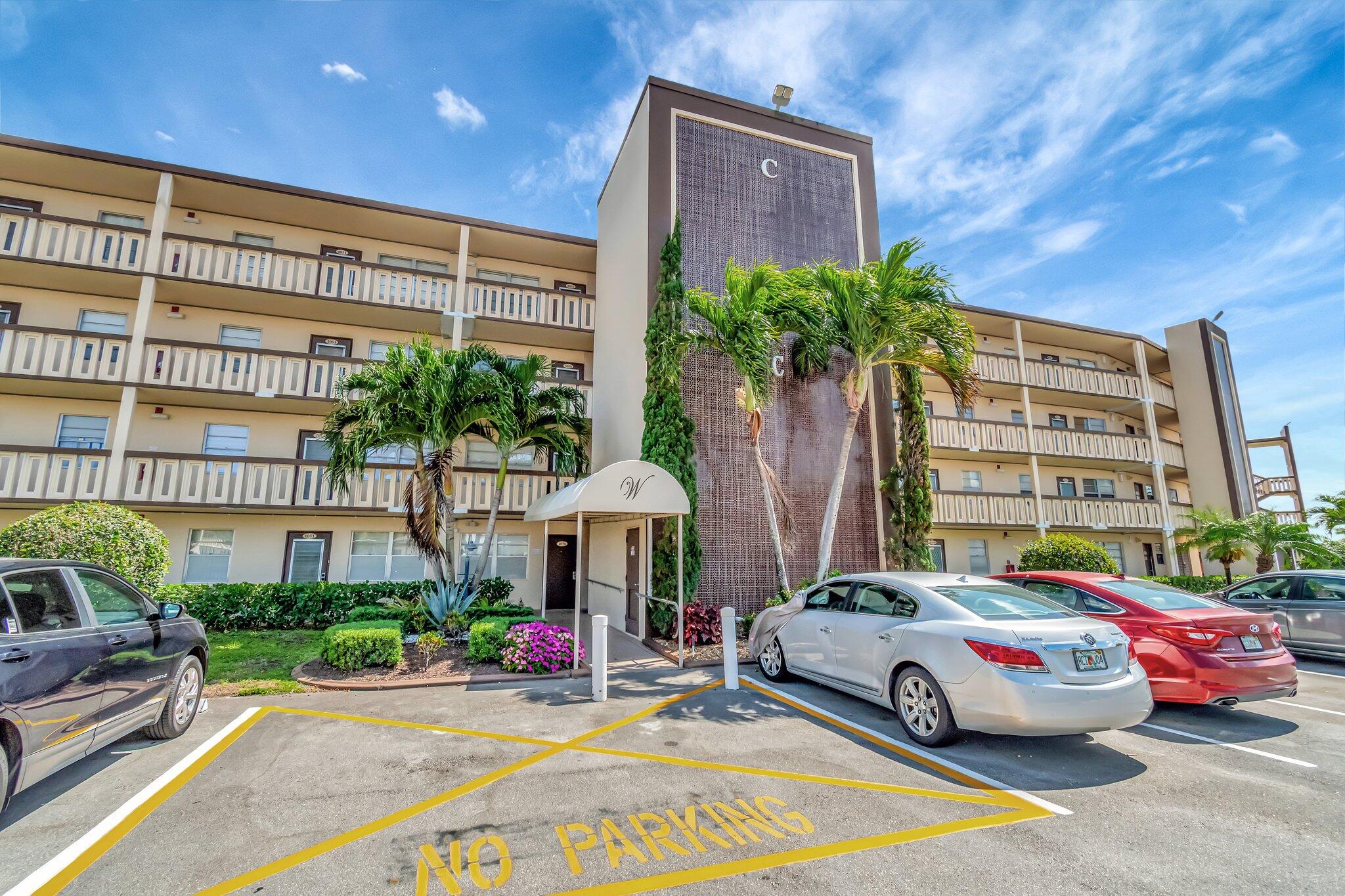 4049 Wolverton C Boca Raton, FL 33434 - Photo 50 of 88 a front view of a house with a yard