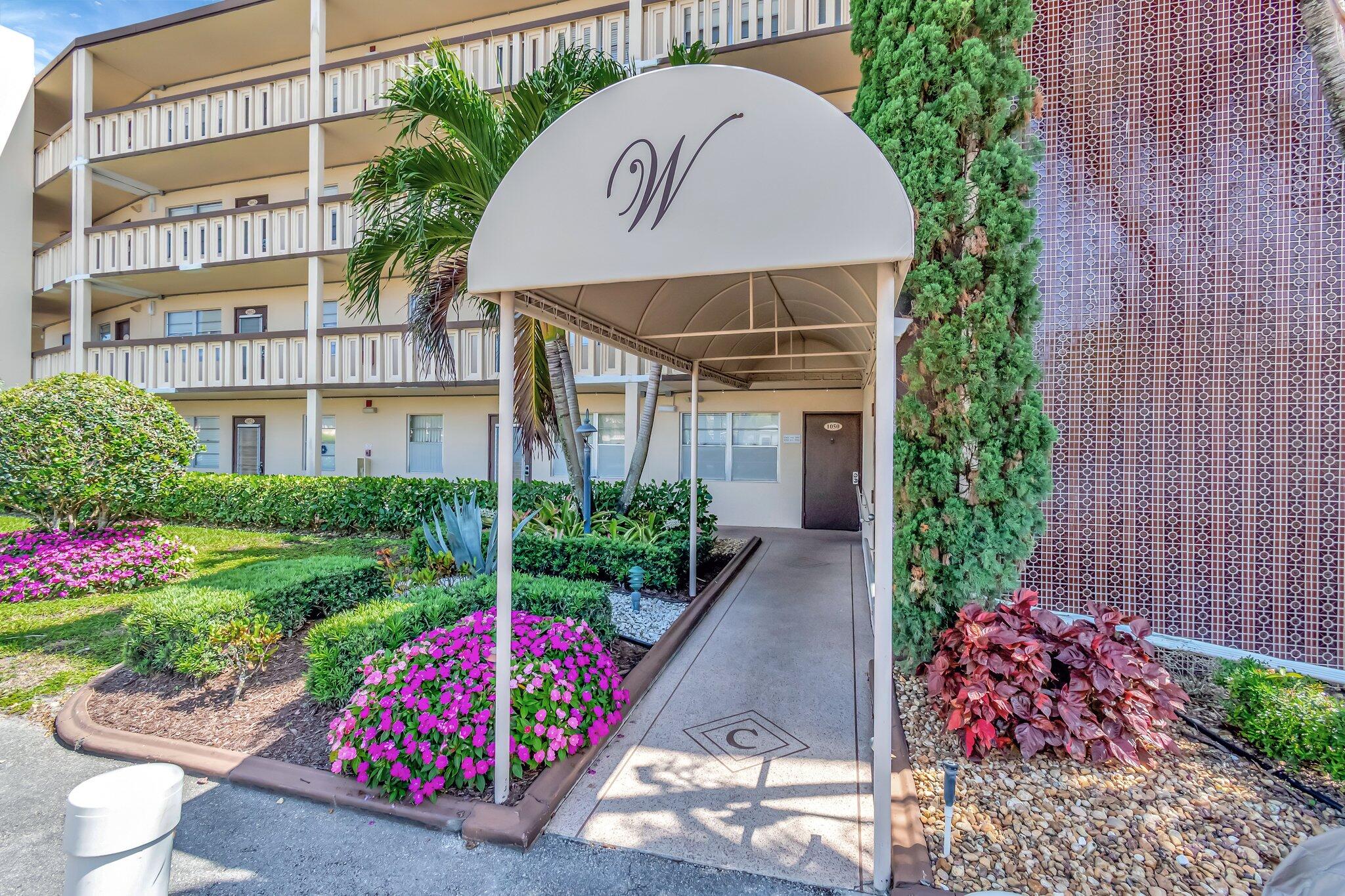 4049 Wolverton C Boca Raton, FL 33434 - Photo 52 of 88 a front view of a house with a yard and fountain