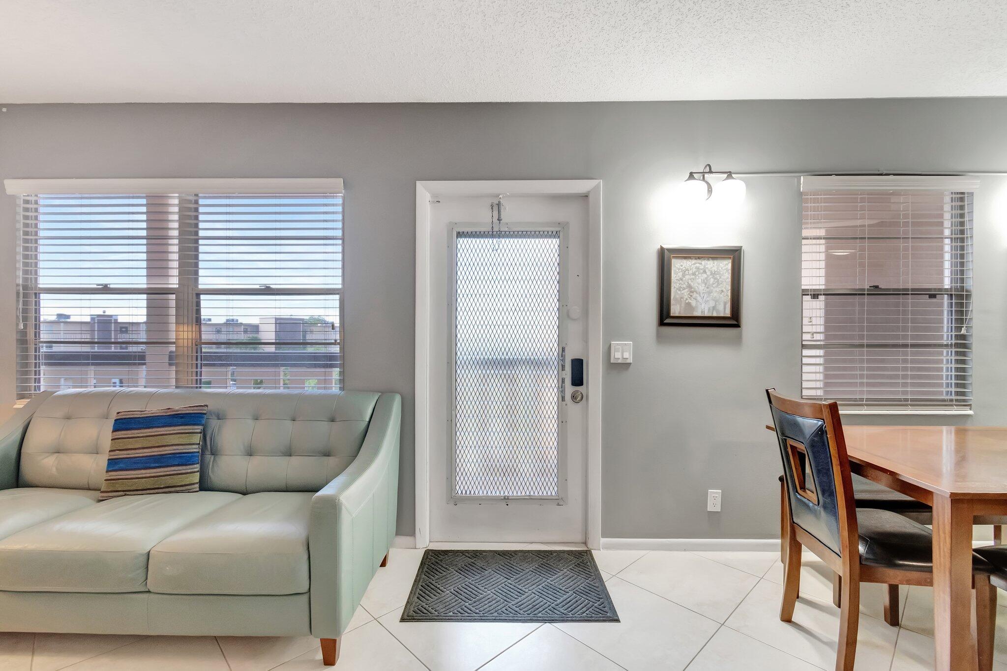 4049 Wolverton C Boca Raton, FL 33434 - Photo 9 of 88 a living room with furniture and a window
