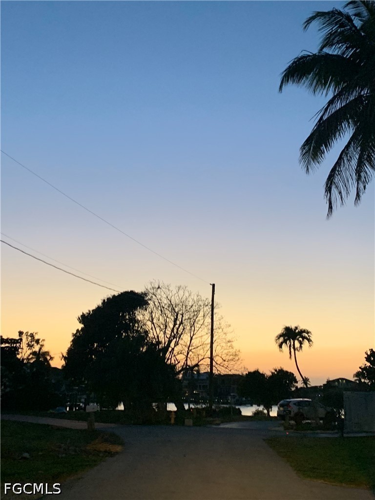 a sunset view with a lake
