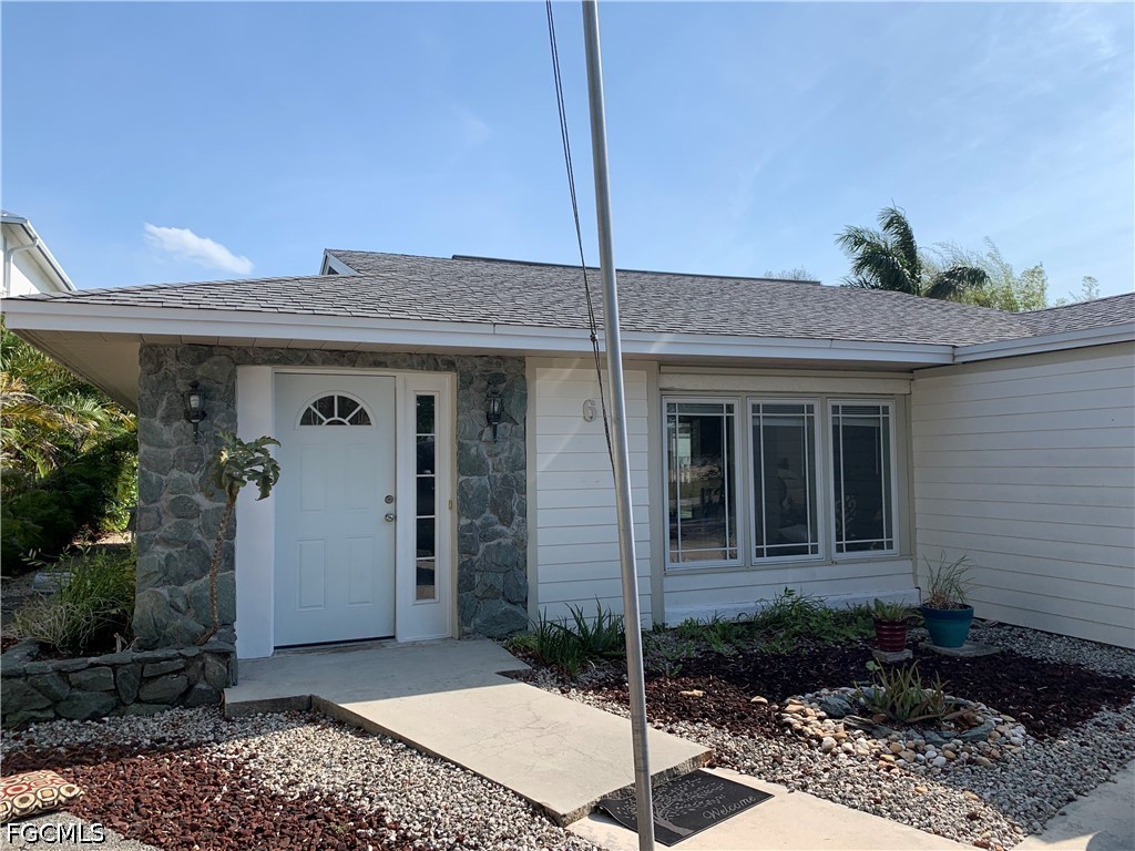 6 Hawk Street Naples, FL 34113 - Photo 2 of 5 a view of a house with potted plants