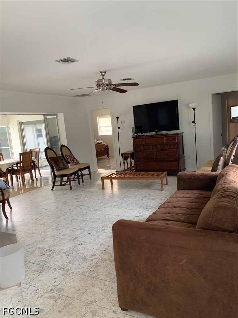 6 Hawk Street Naples, FL 34113 - Photo 4 of 5 a living room with furniture and a flat screen tv