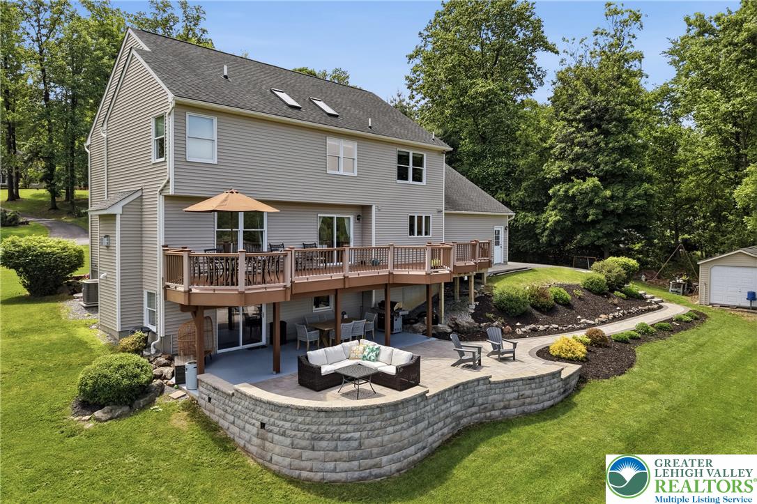 115 West Butternut Road Hellertown, PA 18055 - Photo 71 of 97 An inviting tiered patio and deck combination provide ample space for outdoor enjoyment, overlooking a meticulously landscaped yard.
