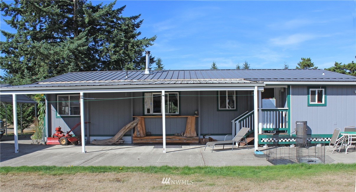17238 Weaver Lane Southwest Rochester, WA 98579 - Photo 2 of 24 a view of a house with a patio and a yard