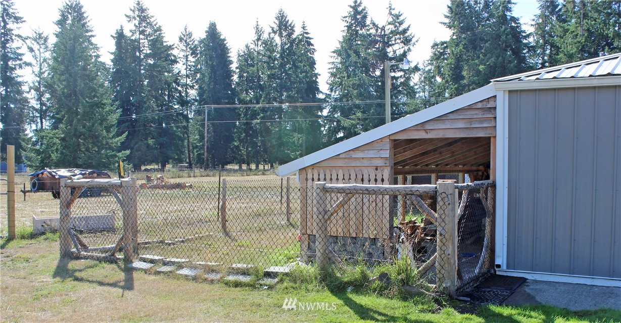 17238 Weaver Lane Southwest Rochester, WA 98579 - Photo 11 of 24 a view of a chair and table in the back yard of the house