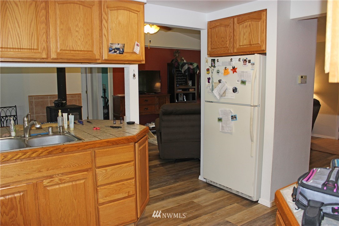 17238 Weaver Lane Southwest Rochester, WA 98579 - Photo 17 of 24 a view of kitchen with stainless steel appliances granite countertop a refrigerator and a stove