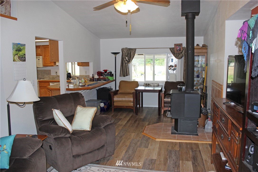 17238 Weaver Lane Southwest Rochester, WA 98579 - Photo 23 of 24 a living room with furniture a window and a flat screen tv