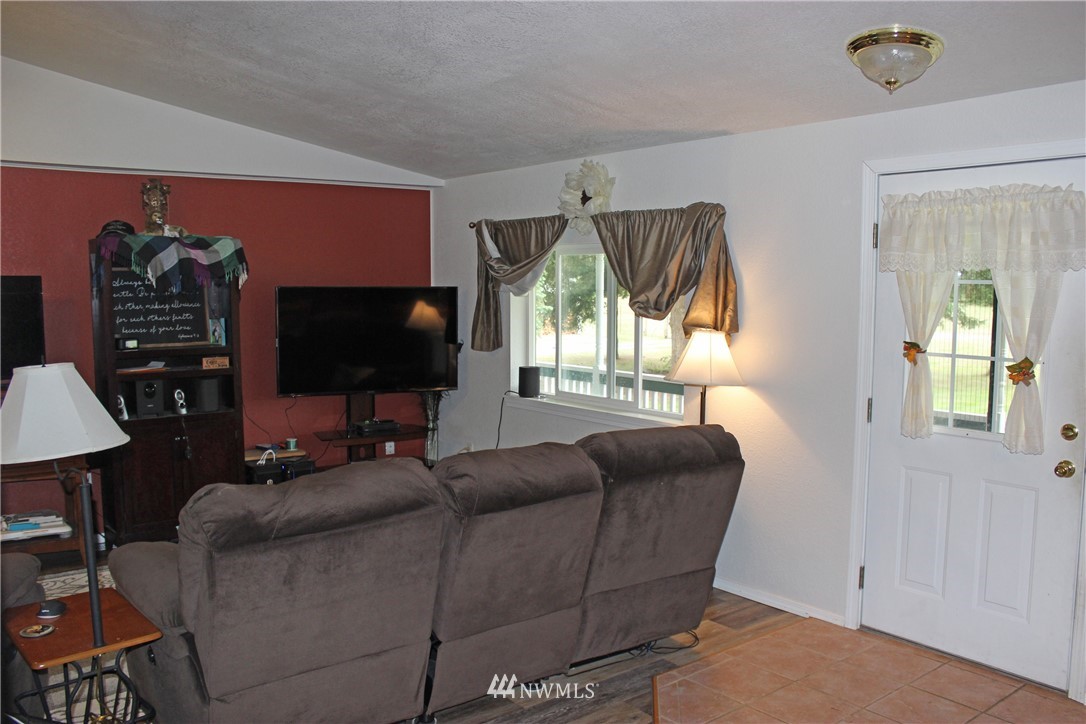 17238 Weaver Lane Southwest Rochester, WA 98579 - Photo 24 of 24 a living room with furniture a flat screen tv and a large window