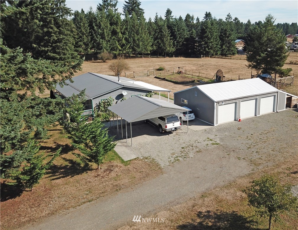 17238 Weaver Lane Southwest Rochester, WA 98579 - Photo 4 of 24 an aerial view of a house with a yard and trees all around