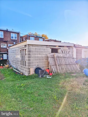 a view of a house with a yard and sitting area