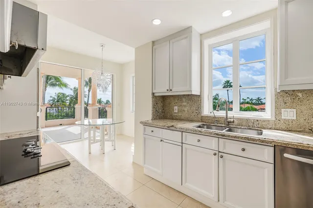 a kitchen with a sink stove and cabinets