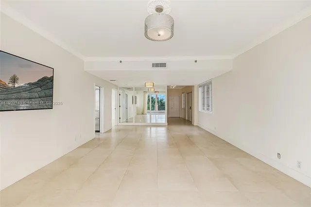 a view of a livingroom with wooden floor and window