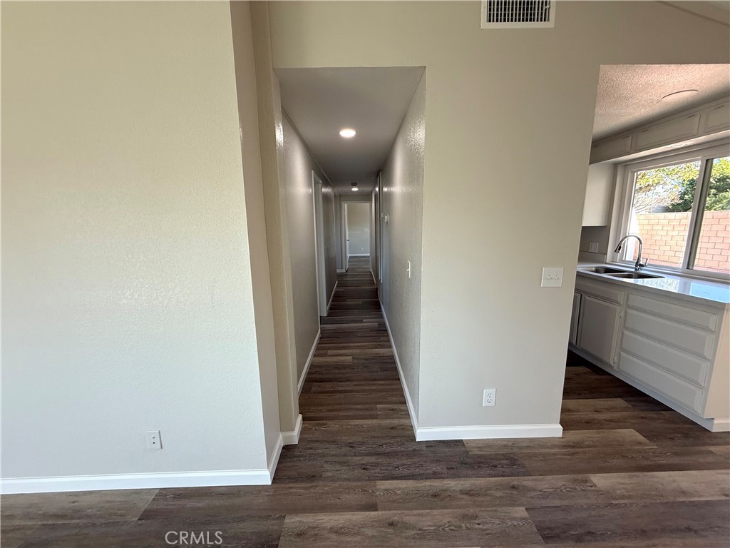 3445 Sparrow Circle Riverside, CA 92503 - Photo 14 of 41 a view of a hallway with wooden floor and glass doors