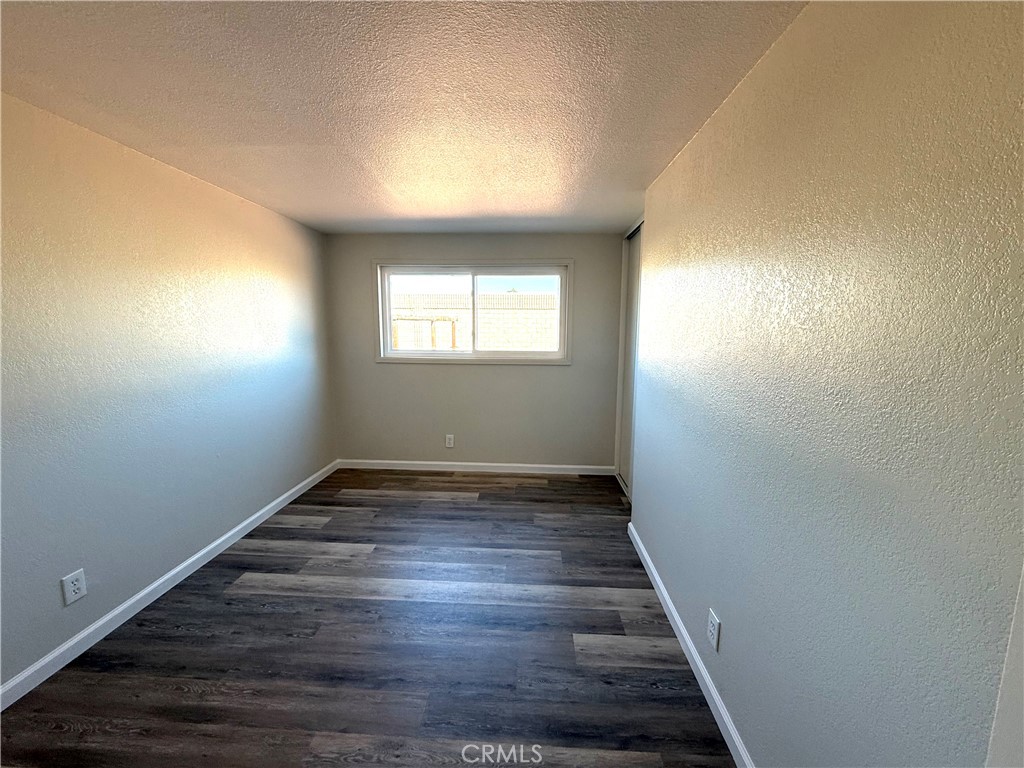 3445 Sparrow Circle Riverside, CA 92503 - Photo 17 of 41 an empty room with wooden floor and windows